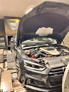 Grey Audi S5 with open hood inside the Tune Technic workshop for a performance chip tune remap
